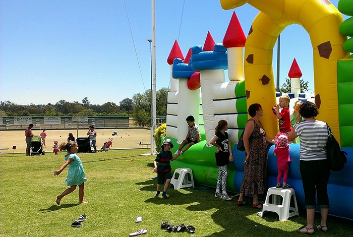 Children playing in a jumping castle setup on the grounds